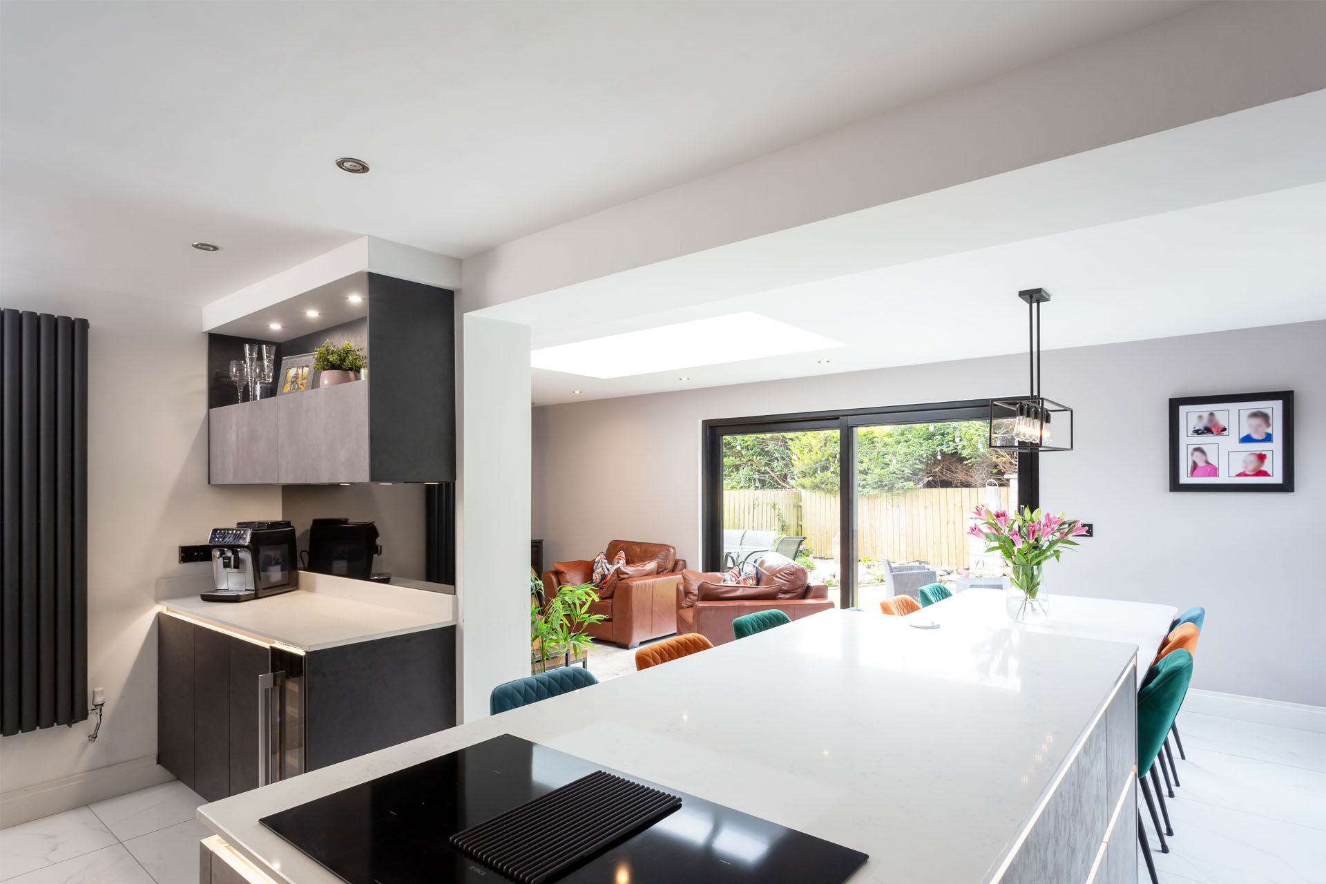A modern kitchen with rear garden sliding door and a splash of colour