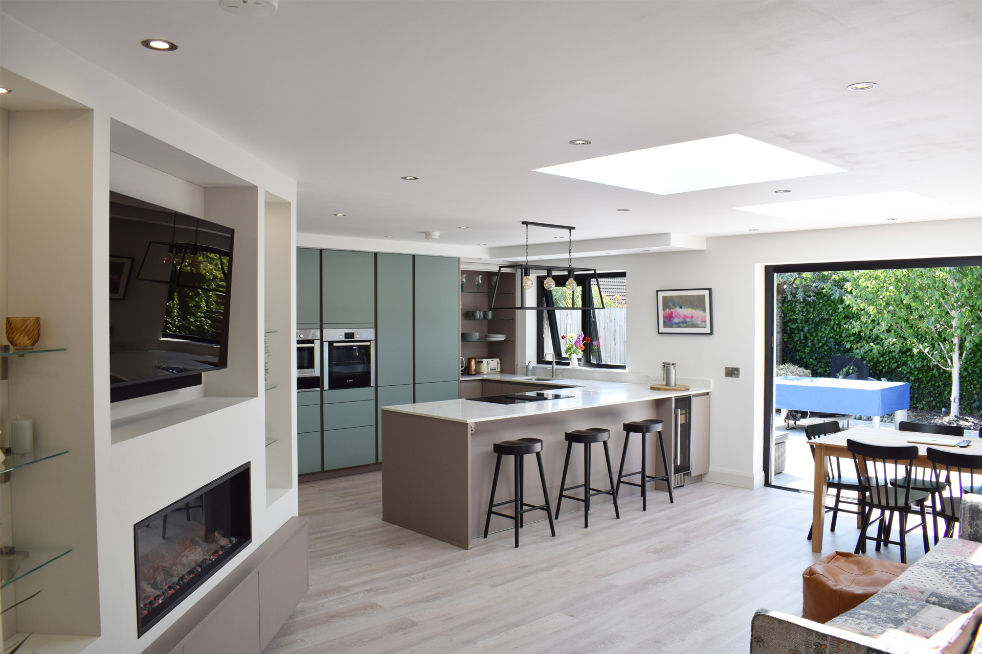 Modern kitchen with beautiful colours and natural light from the large garden doors